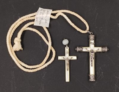 two crosses and a rope on a black surface