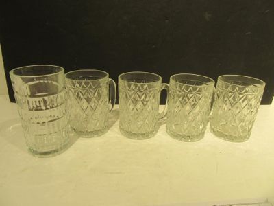 six glasses are lined up in a row on a counter