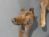 a wooden animal head on a stick on a table