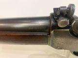 an old gun that is on display in a glass case