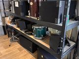 a shelf that has a lot of musical equipment on it