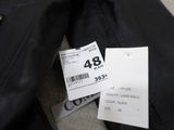 a black jacket and a white tag on the back of the jacket