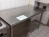 a kitchen with a stove, sink, and counter in it