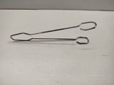a pair of safety pins on a white surface