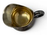 an image of a metal cup with a handle on a white surface