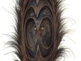 an image of a wooden mask with feathers on a white background