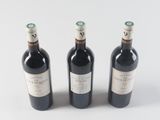 three bottles of wine sitting next to each other on a table