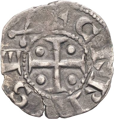 une vieille pièce d'argent sur laquelle figure une croix sur fond blanc