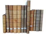 a lot of old books that are stacked on top of each other