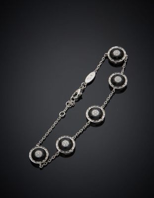un bracelet en argent orné de pierres noires et blanches sur fond noir