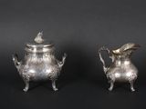 pair of antique silverplated teapots on stands