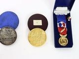 three medals and a medal in a blue case