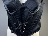 a close up of a black corset on a mannequin torso