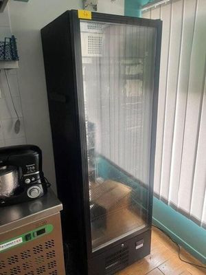 a refrigerator and a coffee maker in a kitchen