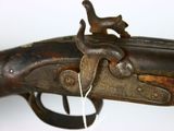 an old gun with a wooden handle and a metal handle