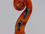 a close up of the back of a violin with a fiddle in the foreground