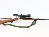 an image of a rifle with a scope on a white background