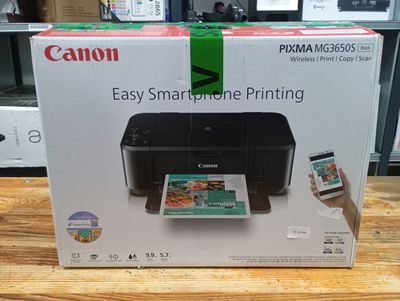 the box of a canon printer is open on the table
