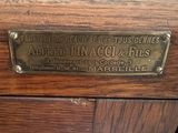 a wooden cabinet with a brass plate on it