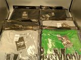 a lot of t - shirts that are sitting on a shelf