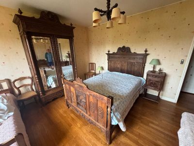 a bedroom with a bed, dresser, and mirror in it
