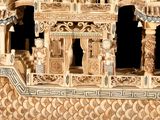 a small wooden structure with carvings on it