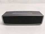 an image of a black and silver speaker on a white surface