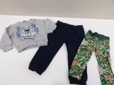 three pieces of clothing are laid out on a white surface