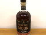 an image of a bottle of whiskey on a wooden table