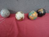 three balls of yarn and a ball of yarn on a red cloth