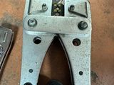 a pair of pliers and a cell phone on the floor