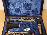 a clarinet in a case sitting on top of a wooden table