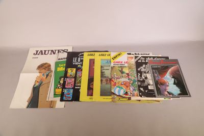 a bunch of books sitting on top of a table next to each other