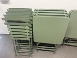 many green folding chairs sitting in a room