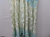 two women ' s dresses hanging on a rack in front of a white wall