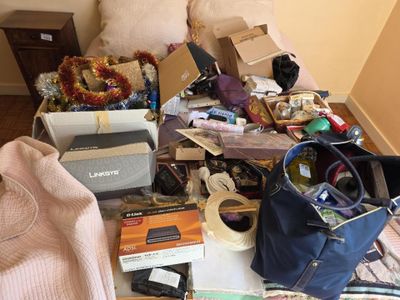 a pile of clutter on a bed in a room