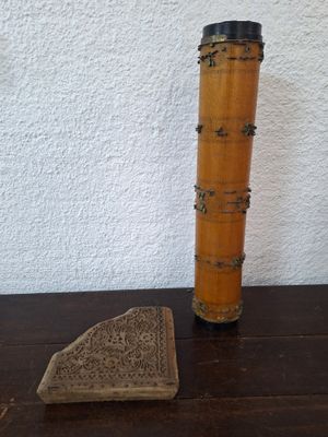 a small piece of wood sitting on a table next to a small piece of wood
