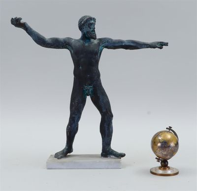 a statue of a man holding a globe next to a statue of a man