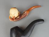a pipe with a skull on it and a skull in it
