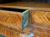 a wooden desk with two drawers and a plaque on it