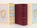 trois livres posés l'un à côté de l'autre sur une surface blanche