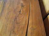 a close up of a wooden bench with a wooden seat