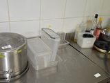 stainless steel counter top with a pot on top of it in a kitchen