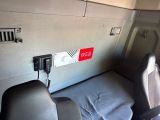 a bed in the back of a van with a phone on it