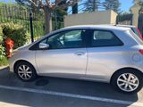 a silver car parked in a parking lot next to a fire hydrant