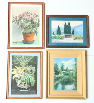 four framed paintings of flowers on a wall in a room