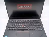 a black laptop with a red lenovo logo on the screen