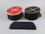 three hats and a wallet sitting on a table