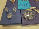 a lot of glass ornaments on a table with a price tag