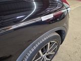 a close up of a black car with a sticker on it
